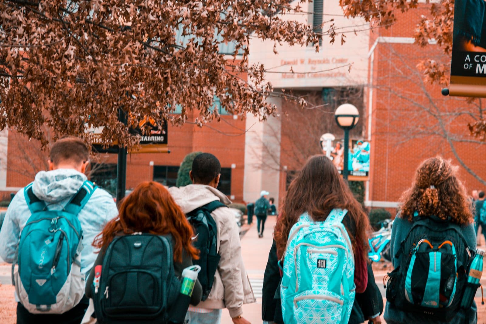 Students walking toward a brick school building