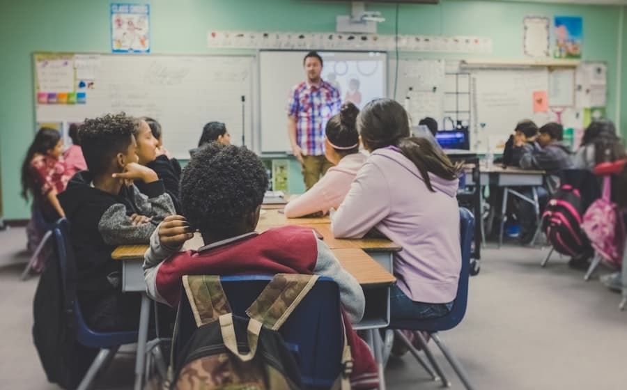 Students listening to a teacher in class
